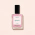 A square glass bottle of Manucurist nail polish in the shade Halo, a milky mauve color with a black cap, is shown against a light beige background.