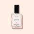 A bottle of Manucurist nail polish in the shade Bliss—an opaque pearly white—displayed elegantly on a light beige background.