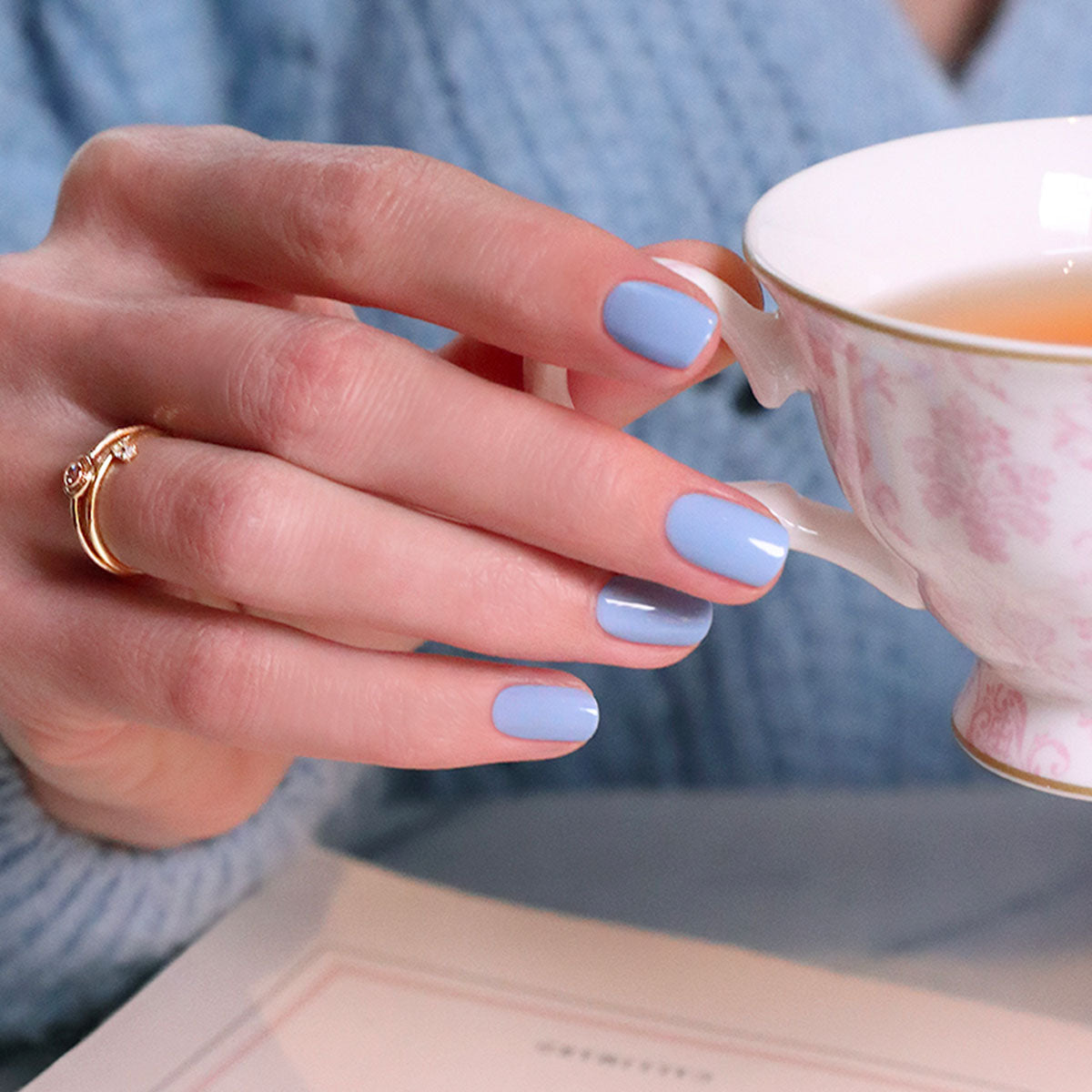 A hand with neatly manicured nails polished in Manucurist&