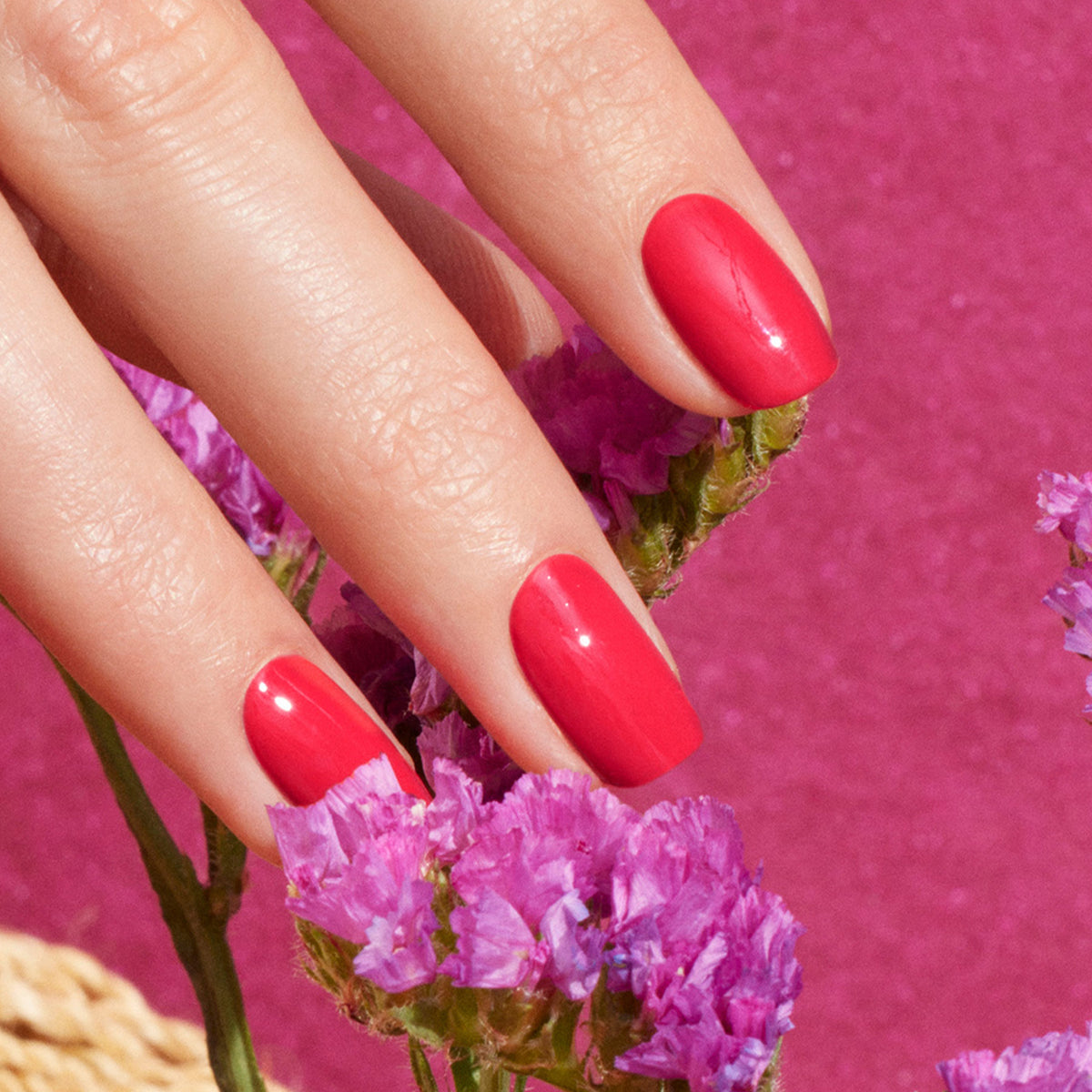 A hand with perfectly manicured nails painted in Manucurist&