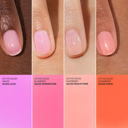 Four hands with manicured nails, each painted a different glossy shade from Manucurist—featuring the vibrant Active™ Glow Raspberry—showcase plant-based nail care. Beneath each hand lies a label matching its color and shade name. The background seamlessly blends with the nail tones, highlighting both style and nourishing benefits.