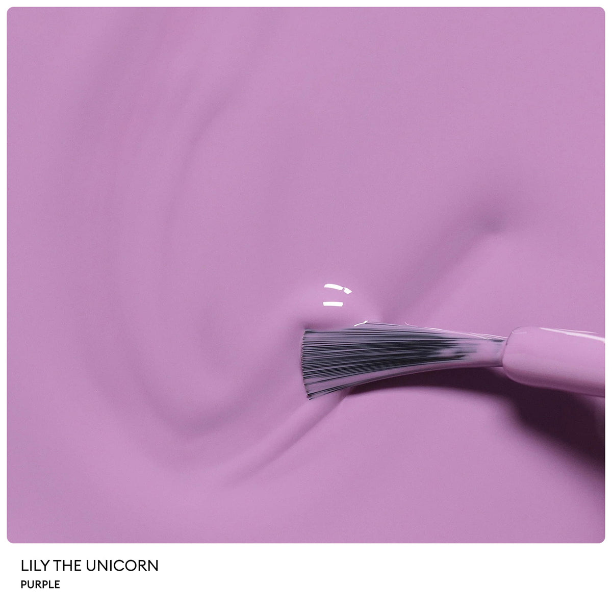 A close-up of a nail polish brush gliding rich, glossy purple polish across a smooth surface. From the Manucurist Petite Manucurist Trio, this natural origin children’s nail polish in the shade Lily the Unicorn makes an ideal holiday gift.