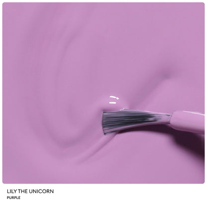A close-up of a nail polish brush gliding rich, glossy purple polish across a smooth surface. From the Manucurist Petite Manucurist Trio, this natural origin children’s nail polish in the shade Lily the Unicorn makes an ideal holiday gift.