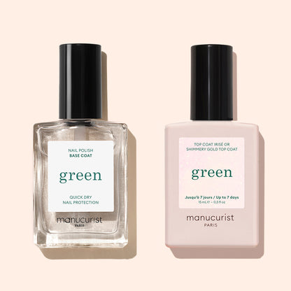 Two Manucurist nail products stand upright on a beige background: a clear Green base coat (left) and the Glitter Top Coat with gold shimmer and a pale pink label (right).
