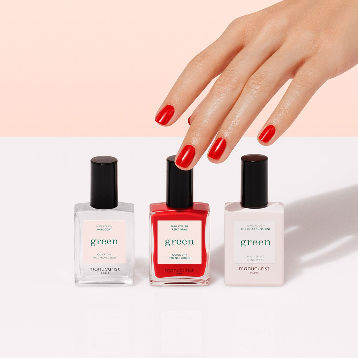 A hand with neatly manicured red nails reaches for Manucurist&