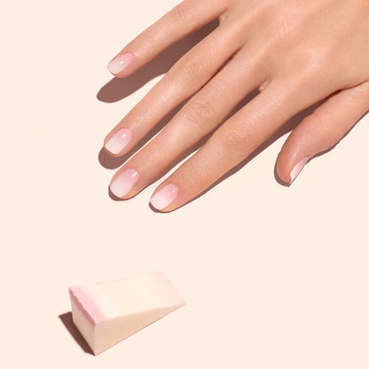 A hand with neatly manicured, natural nails rests on a light surface. Nearby, Manucurist Nail Art Sponges - x4 suggest the perfect tool for creating soft Baby Boomer nails.