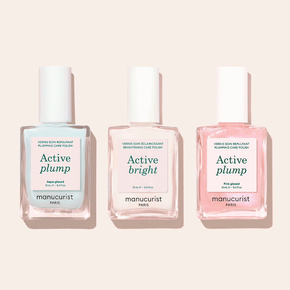 The Manucurist Customizable Active™ Trio, featuring three nail care polishes, is displayed side by side on a light beige background—each polish designed for personalized makeup effects.