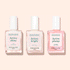 Three glass bottles from the Manucurist Customizable Active™ Trio—labeled Active Shine, Active Bright, and Active Plump—stand side by side on a pale pink background. These nail care polishes feature pale pink and clear shades, ideal for achieving a personalized look with natural makeup effects.