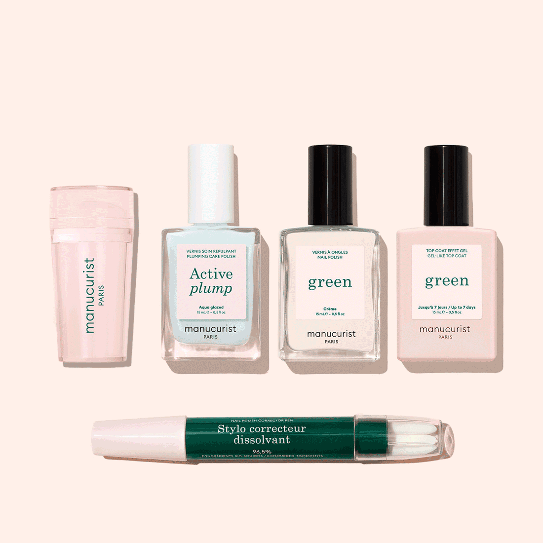 Five manicure products from Manucurist’s French Active™ Kit are shown on a beige background: a pink cylindrical container, a square bottle labeled Active blur, two green-labeled nail polish bottles, and a dual-ended Stylo correcteur pen.