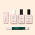 Five manicure products from Manucurist’s French Active™ Kit are shown on a beige background: a pink cylindrical container, a square bottle labeled Active blur, two green-labeled nail polish bottles, and a dual-ended Stylo correcteur pen.