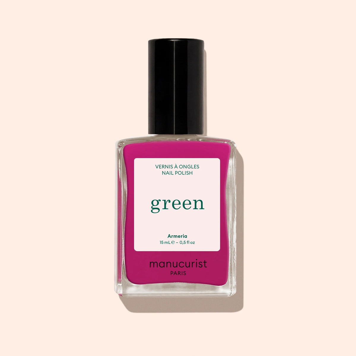 Un flacon rectangulaire de vernis à ongles Manucurist Armeria rose mauve, avec un bouchon noir et une étiquette portant les mentions « VERNIS À ONGLES NAIL POLISH », « green », « Armeria », « 15 mL – 0,5 fl oz » et « manucurist PARIS ».