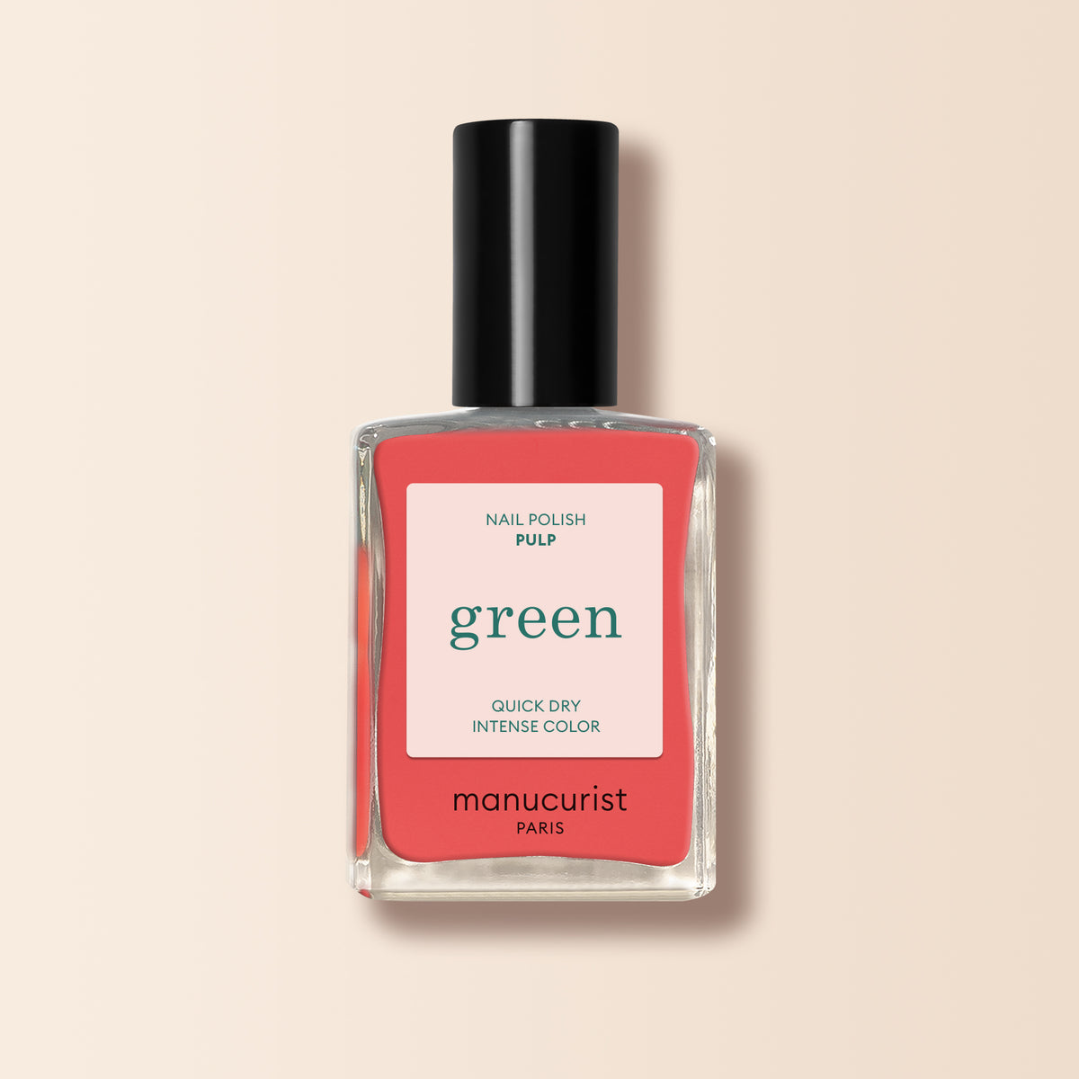A Manucurist Pulp nail polish bottle with a black cap and a pink-white label stating Quick Dry Intense Color. Ideal for grapefruit shade fans, this Green range polish stands out against a light beige background.