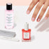 A hand with manicured nails is reaching toward the Manucurist Active Discovery Kit, featuring nail care essentials like nail polish remover, nail polish, and nail files—all arranged on a light surface—perfect for hydrating nails and cuticles as part of your flawless manicure routine.