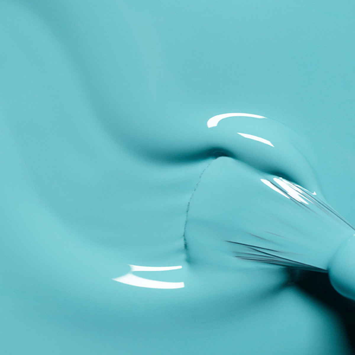 A close-up of a paintbrush applying Manucurist&