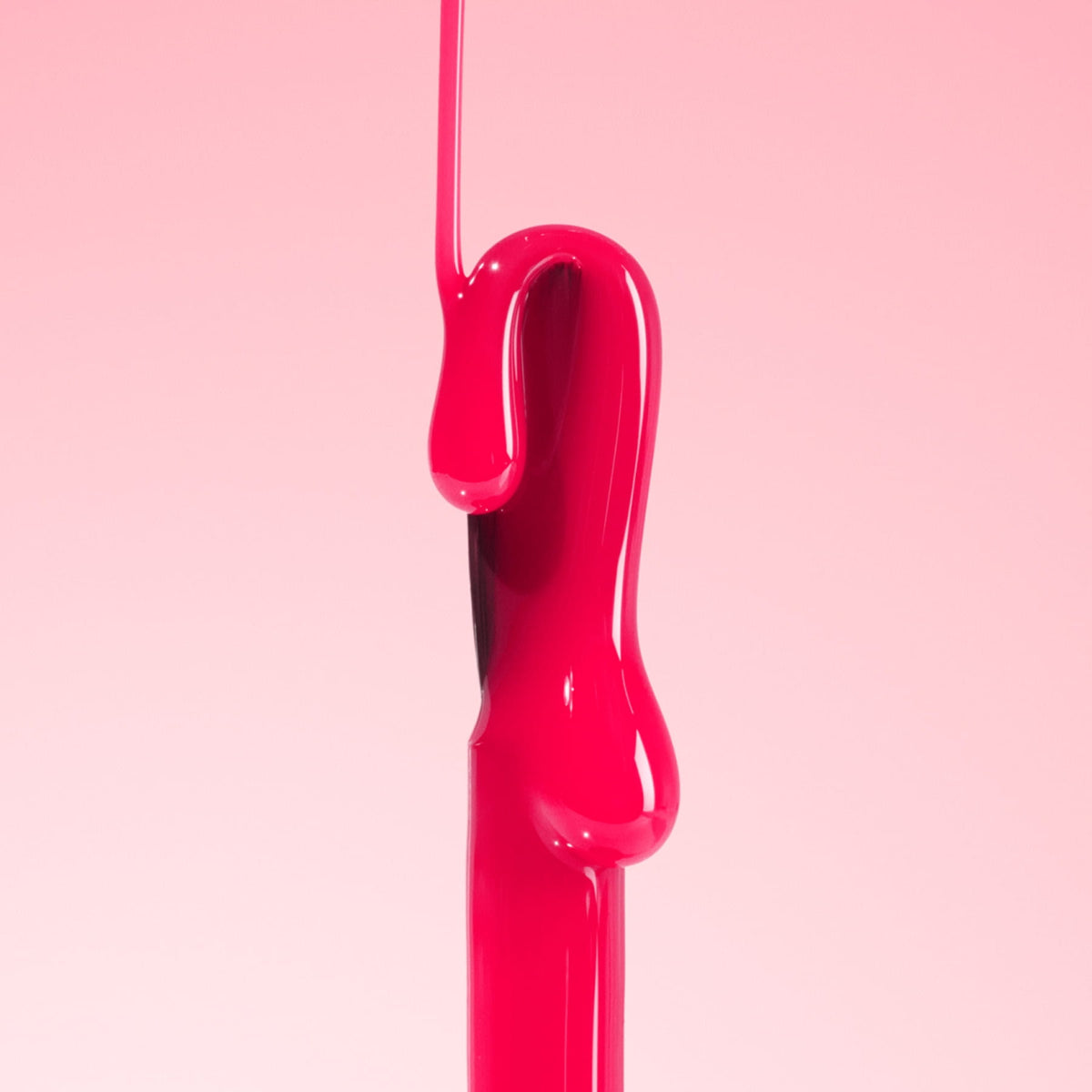 Bright pink liquid drips and flows smoothly down a vertical surface, set against a soft pink gradient background. The liquid is glossy and shiny, creating an abstract shape.
