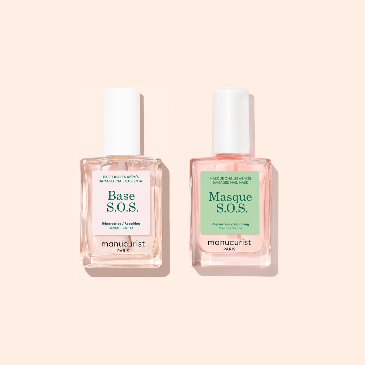 Deux flacons du coffret Basic Routine - Damaged Nails de Manucurist sont placés côte à côte sur un fond beige clair — un duo idéal conçu pour réparer les ongles et renforcer les ongles fragiles.