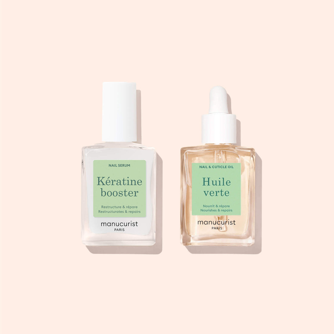 Two glass bottles of Manucurist’s Basic Routine – Soft Nails rest on a pale peach backdrop: a keratin booster for strengthening and Huile verte nourishing cuticle oil.