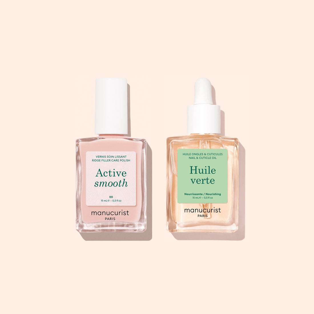 Two square glass bottles from manucurist’s Basic Routine - Ridged Nails set, each with a white cap, labeled Active Smooth (containing pink liquid) and Huile Verte (with yellow liquid), stand side by side on a pale peach background. Specially designed for nail care, these products are ideal for nourishing and smoothing ridged nails and can also be used as cuticle oil to keep nails healthy.