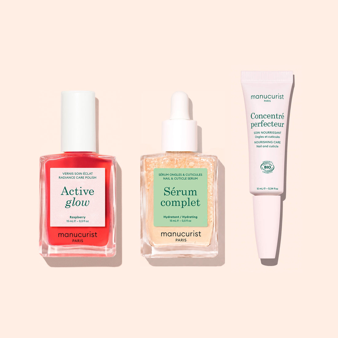 The Basic Routine - Sensitive Nails set from Manucurist features three essential manicure products—a red Active Glow nail polish, a Sérum Complet dropper bottle, and a white Concentré Perfecteur tube—beautifully arranged on a pale pink background to help rescue and moisturize nails.