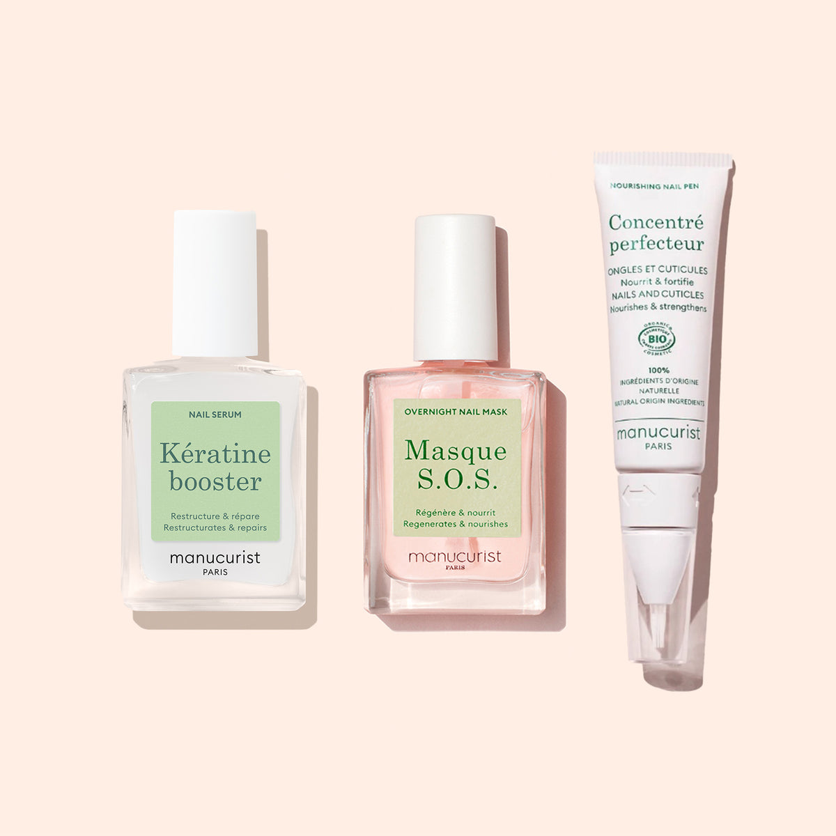 Trois soins des ongles pour manucure sur fond rose clair : un flacon carré de Sérum Fortifiant Manucurist, un flacon carré de Masque S.O.S. de nuit pour les ongles, et un tube de Concentré perfecteur.