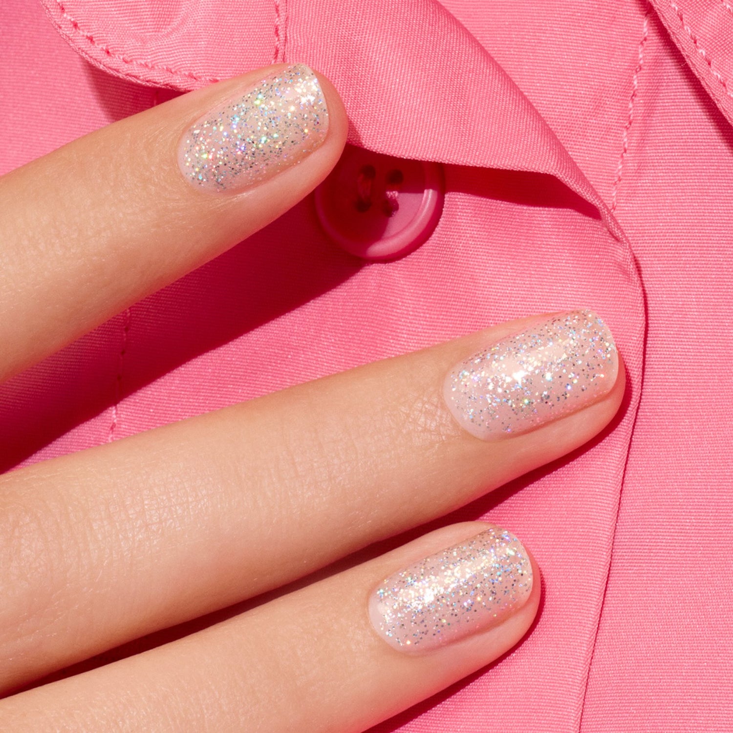 Three fingers with short nails painted in Manucurist&