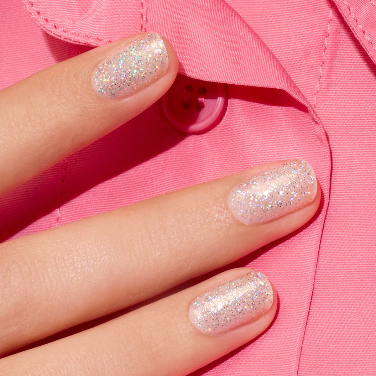 Three fingers with short nails painted in Manucurist&