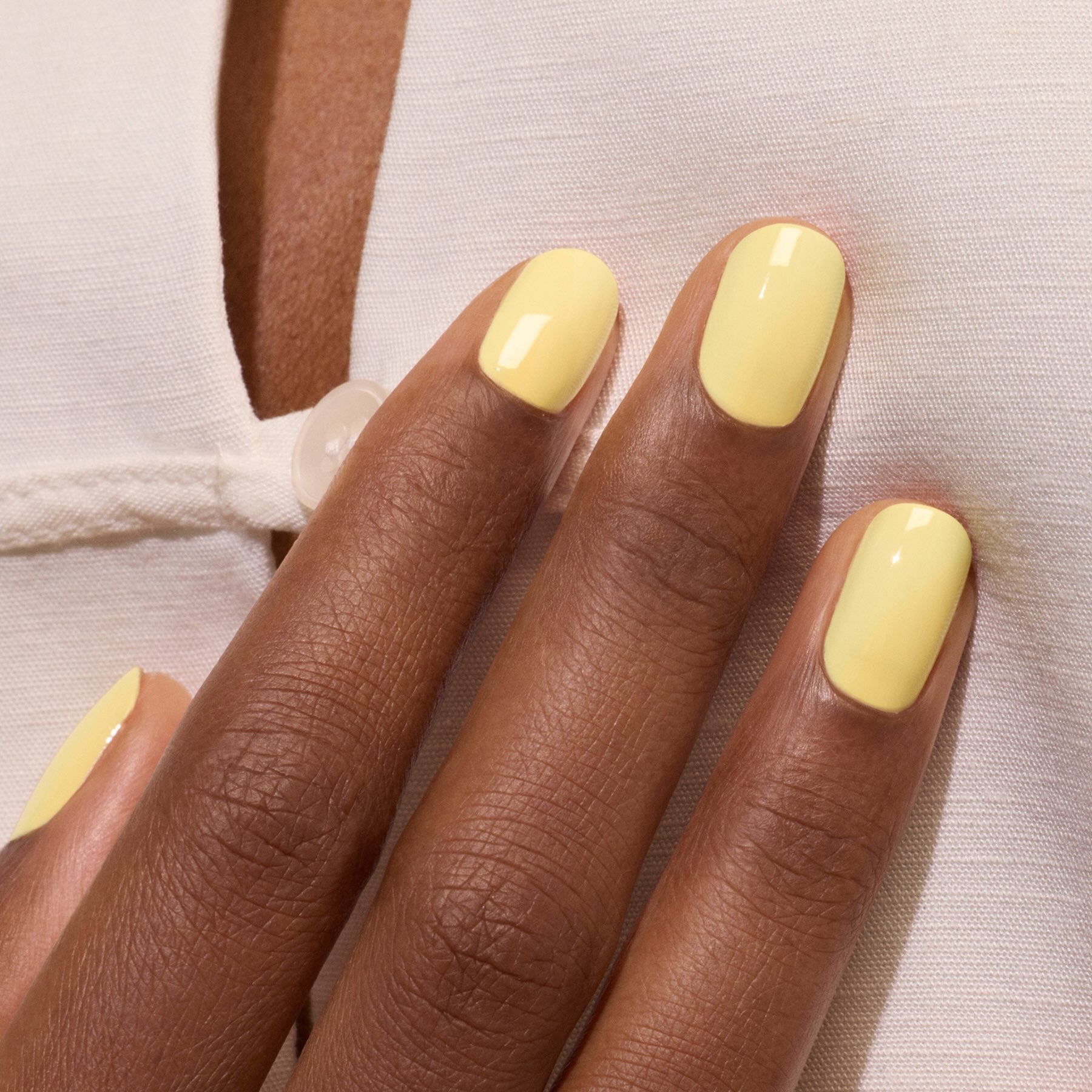 A close-up of a dark-skinned hand wearing Manucurist&