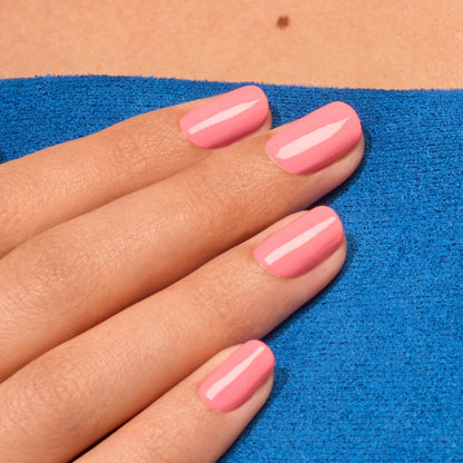 A hand with neatly manicured nails painted in Manucurist&