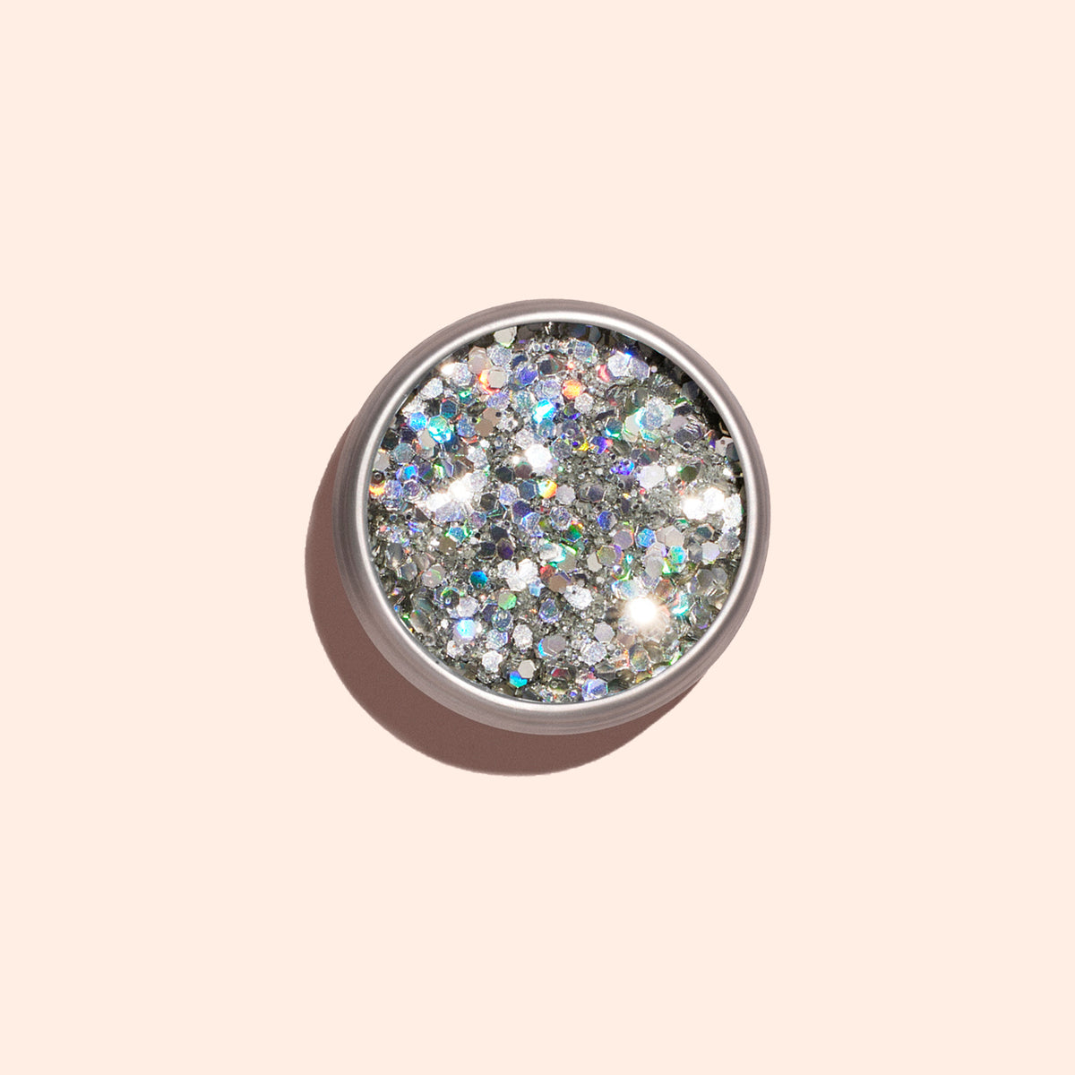 Un pot rond de paillettes biodégradables Holo Manucurist, vu du dessus sur fond beige clair avec une ombre douce — idéal pour apporter une touche scintillante et écoresponsable à votre prochain Nail Art.