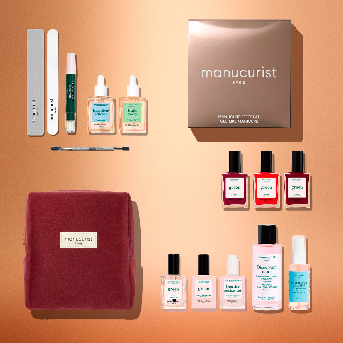 A flat lay of the Green™ Starter Kit Gift Set by Manucurist—including nail files, naturally derived polish bottles, serums, a cuticle tool, a velvet pouch, a spray bottle, and a brown box labeled “manucurist PARIS”—arranged on a peach background makes this the perfect holiday gift for anyone looking to achieve a gel-effect manicure at home.