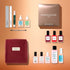 A flat lay of the Green™ Starter Kit Gift Set by Manucurist—including nail files, naturally derived polish bottles, serums, a cuticle tool, a velvet pouch, a spray bottle, and a brown box labeled “manucurist PARIS”—arranged on a peach background makes this the perfect holiday gift for anyone looking to achieve a gel-effect manicure at home.