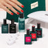 A hand with red polished nails rests on a green Manucurist bag, surrounded by the Manucurist Starter Kit, which includes nail polish, vitaminized base coat, gel polish kit, remover, UV lamp, and care accessories.