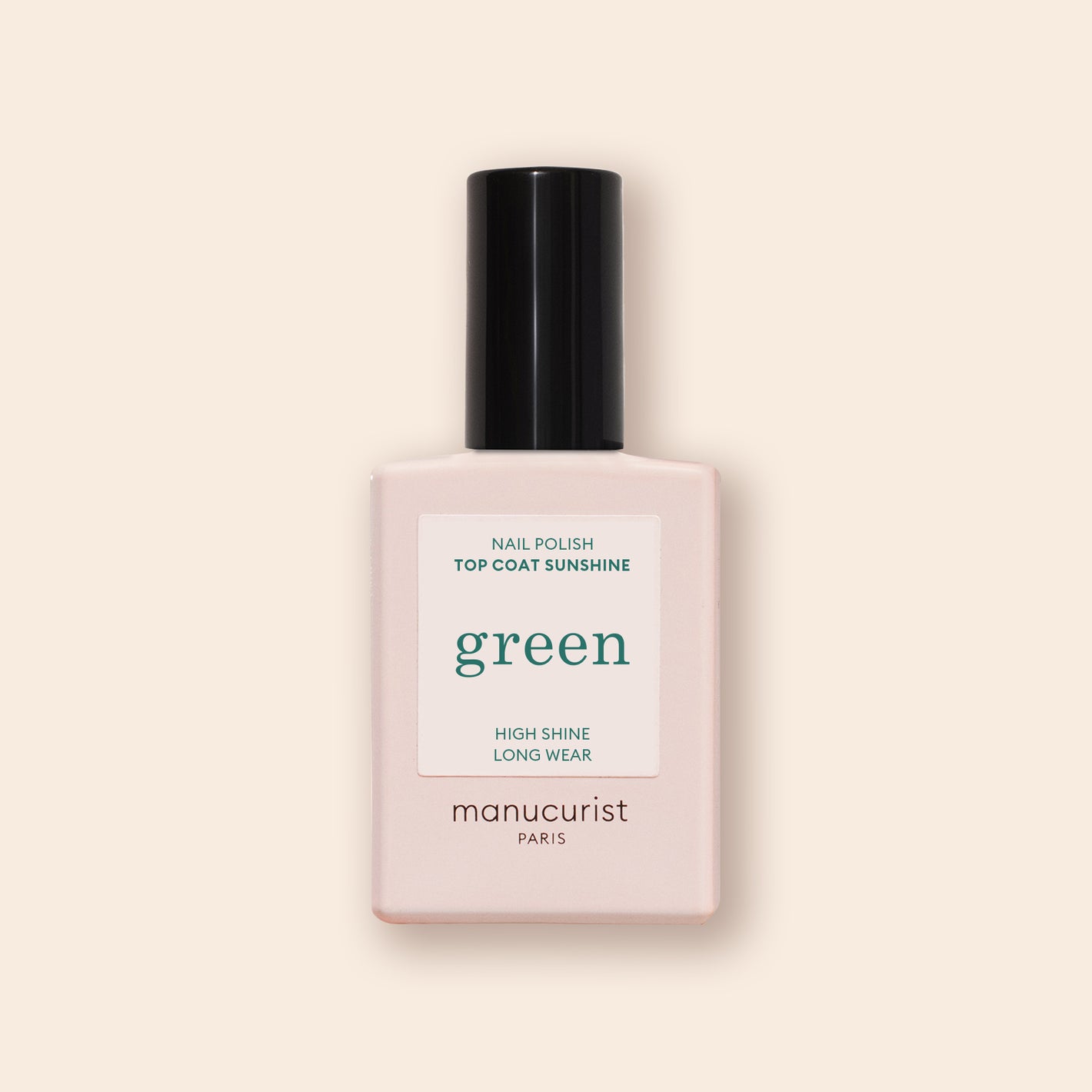 A bottle of Manucurist Green Sunshine Top Coat comes in a pale pink rectangular bottle with a black cap and white label, offering a gel-effect finish with its plant-based formula.
