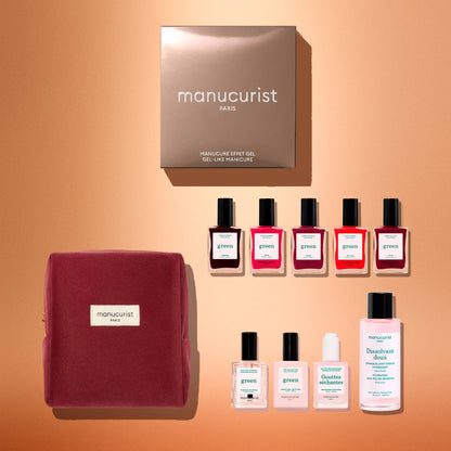 Manucurist’s Green™ Super Starter Kit Gift Set features a pink pouch, a brown box, six naturally derived nail polishes in assorted shades, and four smaller nail care bottles—everything you need for a gel-like manicure—beautifully arranged on a warm beige background.