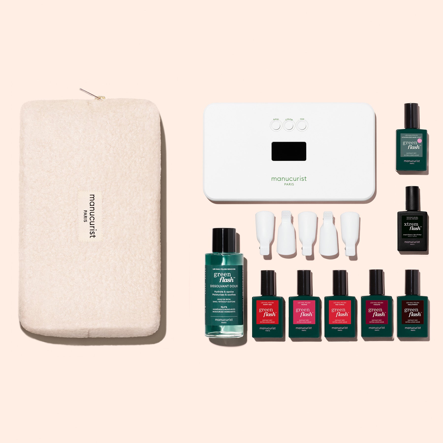 The Manucurist Super Starter Kit includes a soft beige pouch, white LED nail lamp, six vivid gel colors, vitamin-enriched base coat, remover, and four white caps—everything for a high-gloss manicure.
