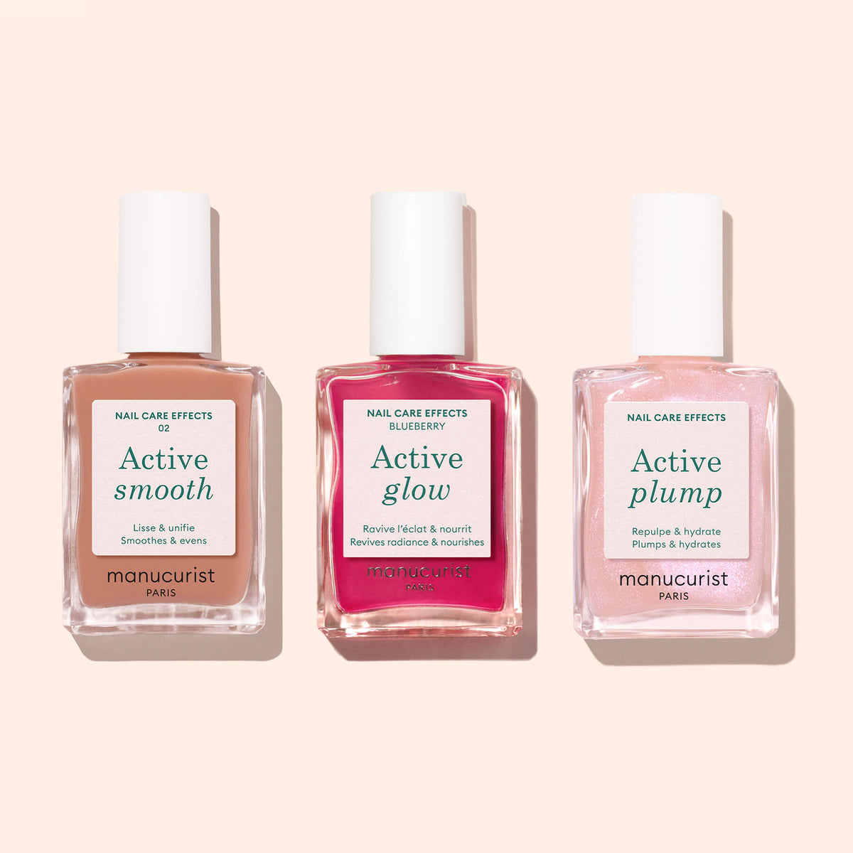 Trois flacons de soins pour ongles Manucurist — Active™ Smooth 02, Active Glow et Active Plump — sont disposés côte à côte sur un fond rose clair, illustrant une routine soin des ongles luxueuse.