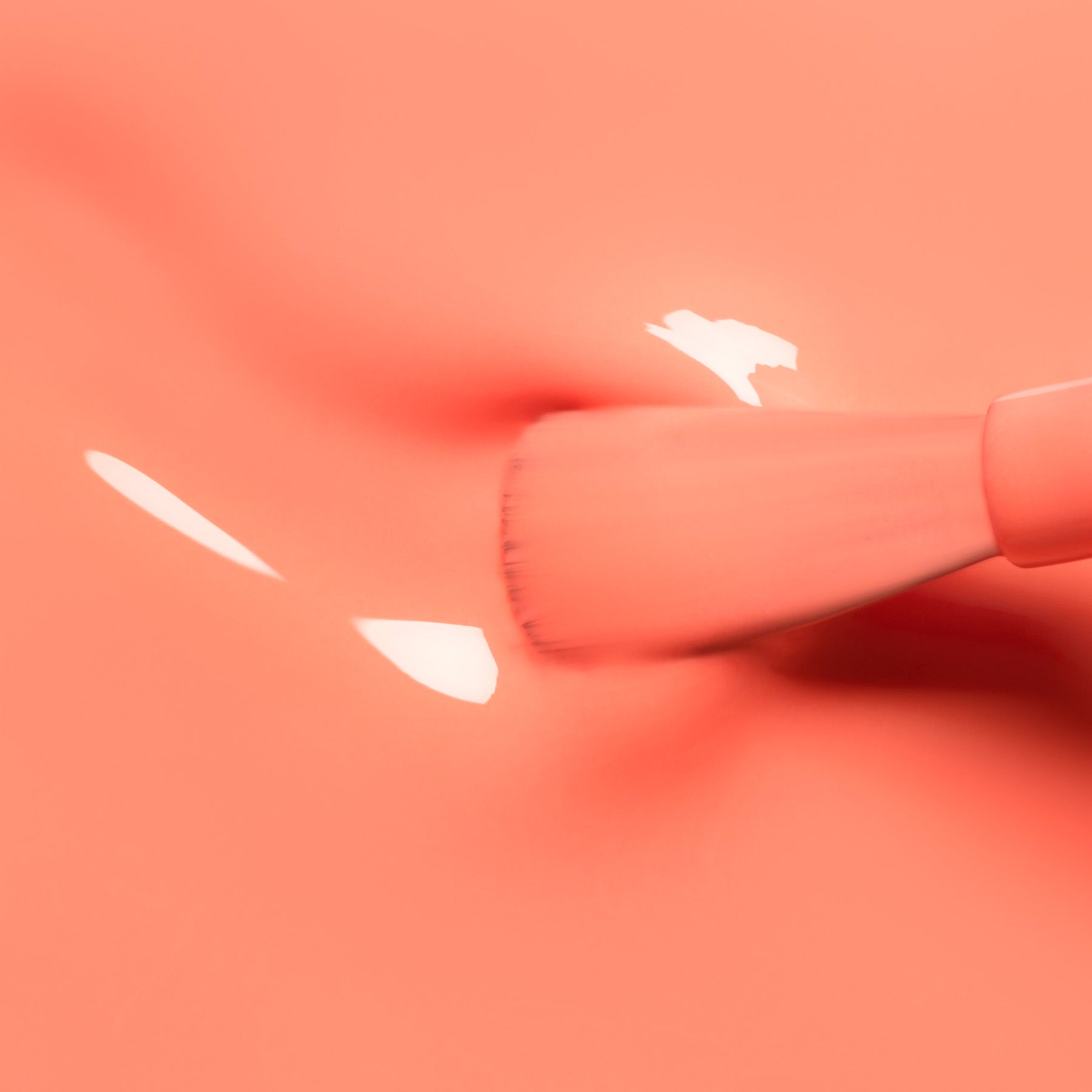 A close-up of a Manucurist Tangerine makeup brush applying glossy coral cream on a smooth, matching background, creating soft reflections and subtle texture reminiscent of neon orange polish.