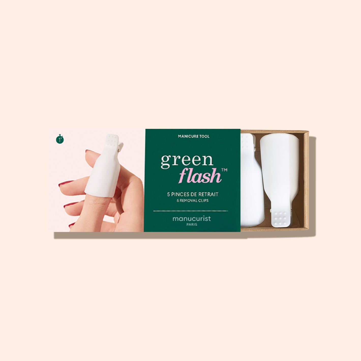 A box labeled green flash containing 5 white nail removal clips by Manucurist Paris. The packaging shows a hand using one of the clips on a fingernail against a light beige background.