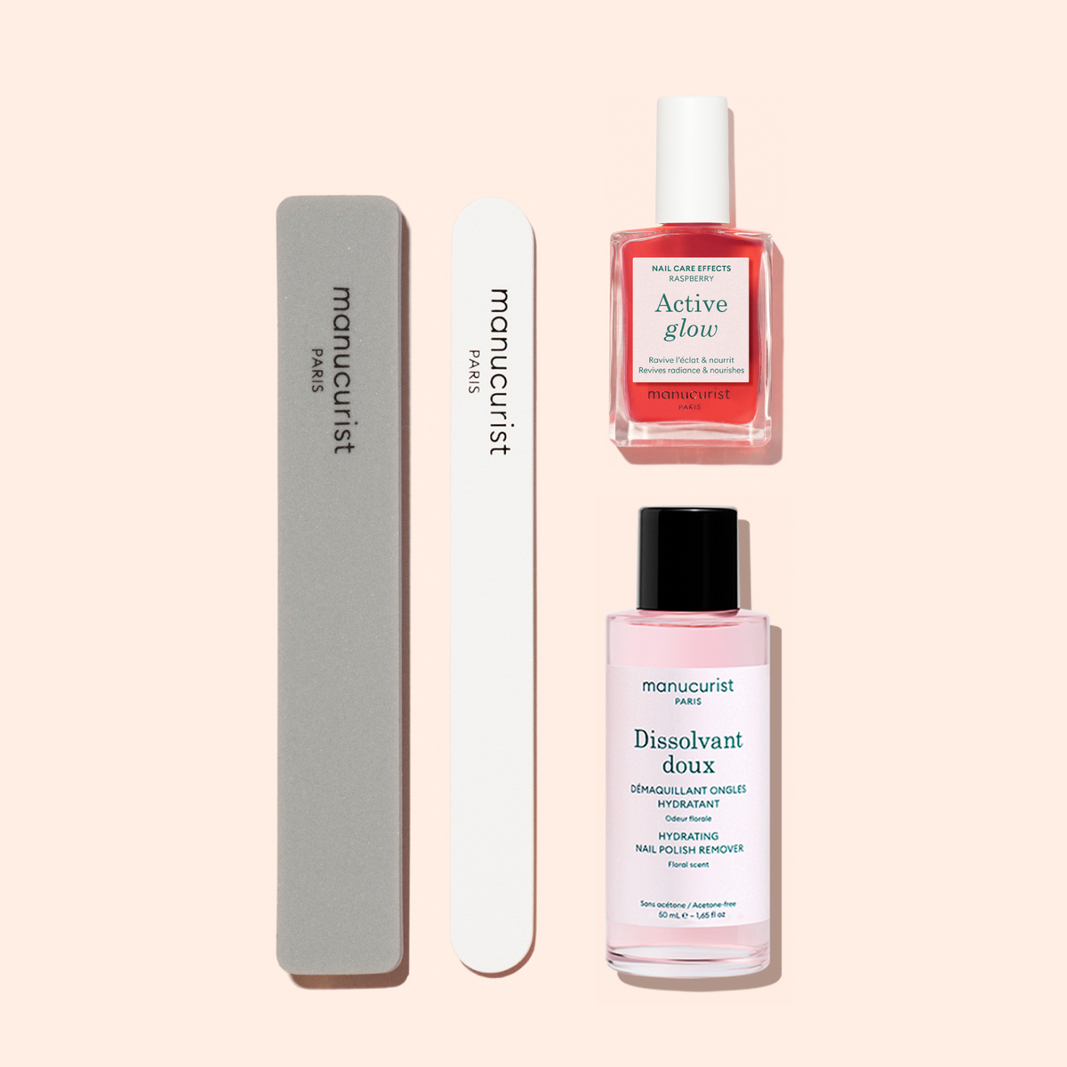 Le Manucurist Active Discovery Kit comprend deux limes à ongles, un flacon rose de vernis à ongles intitulé "Active Glow," et un flacon rose de dissolvant intitulé "Dissolvant Doux," le tout joliment disposé sur un fond beige clair — des outils essentiels pour une manucure impeccable et pour sublimer votre routine quotidienne de soin des ongles.