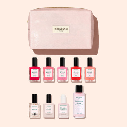 A pink cosmetic bag featuring the Manucurist logo is displayed above the Super Starter Kit - Jelly Nail Polish by Manucurist. The kit includes nine nail care products—colorful gel effect polishes crafted with plant-based ingredients, a remover, a serum, and a top coat—all neatly arranged on a beige background.