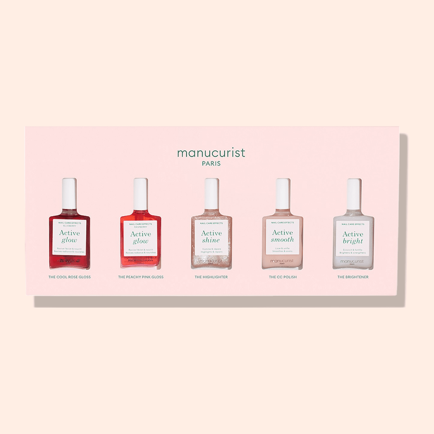 A bottle of Manucurist’s Active Glow Raspberry nail polish is displayed on a light pink background, labeled with its name and description, highlighting its natural radiance for effortless nail care.