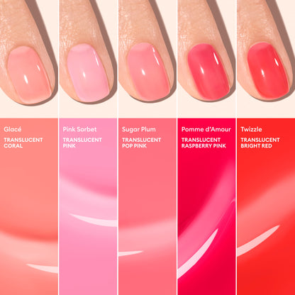 Close-up of five manicured nails, each painted with a different Manucurist Glacé translucent jelly shade—coral, pink, pop pink, raspberry pink, and bright red—each ultra-glossy and labeled with its name and description.