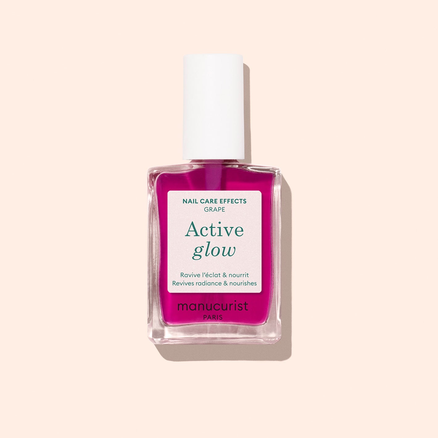 Manucurist Active Glow Grape plant-based nail care polish in a clear rectangular bottle with a white cap, featuring vibrant pink liquid, displayed on a light beige background for ultimate nail nourishment.