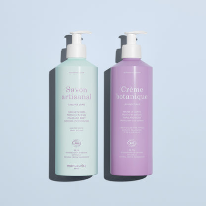 On a light blue background: two pump bottles by Manucurist, including the pale green "Artisan Soap" and the lavender "Organic Lavender Hand  Body Wash - Cosmos Organic," both for hands and body.
