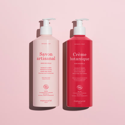 Two pump bottles on a pink background: the left is light pink labeled Savon artisanal, and the right is dark pink labeled Soothing Rose Hand  Body Cream - Cosmos Organic by Manucurist, a deeply hydrating hand and body product.
