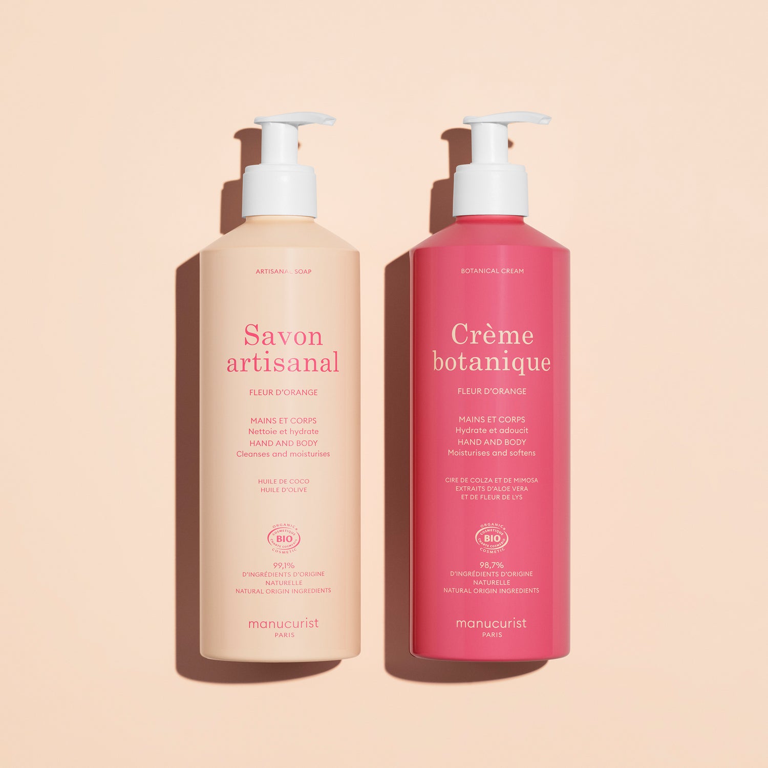 Two Manucurist pump bottles on beige: the light pink is Organic Orange Blossom Hand  Body Wash - Cosmos Organic, the dark pink is Crème botanique. Both for hand and body, scented with orange blossom.