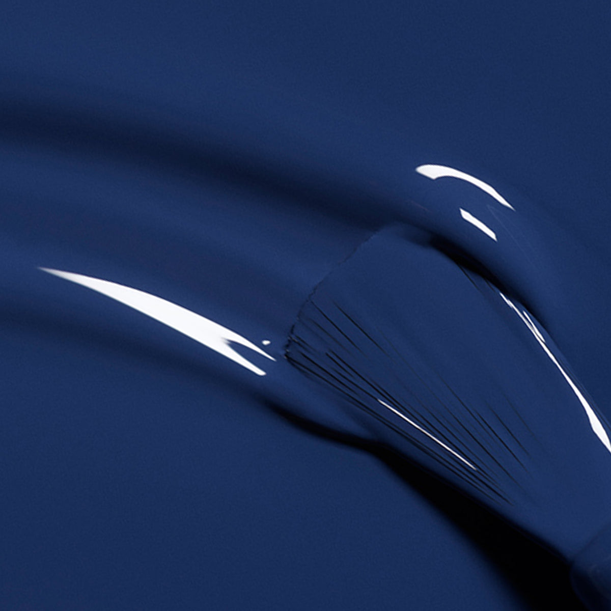 A close-up of a brush spreading Manucurist&