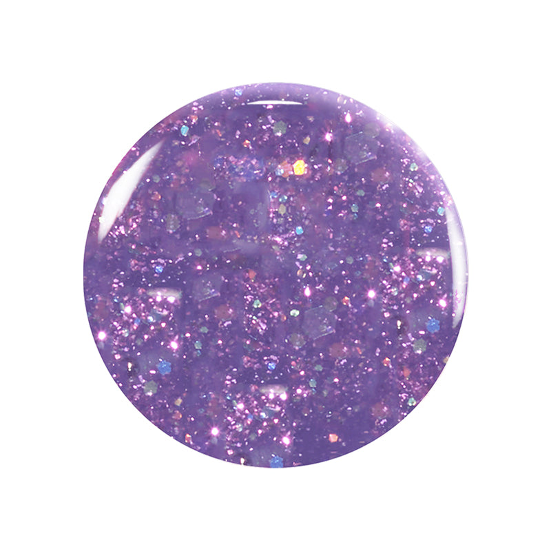A close-up of a round spot of Betty Scarlett Stella Trio nail polish by Manucurist shows glittery purple, non-toxic polish with sparkles and iridescent flecks on a white background.