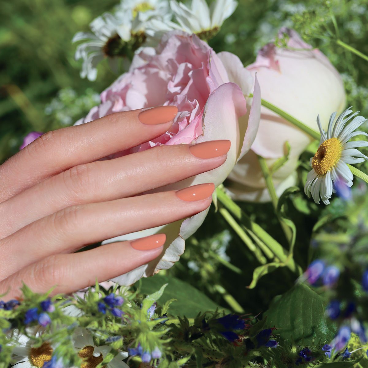 A hand with neatly manicured nails in Manucurist&