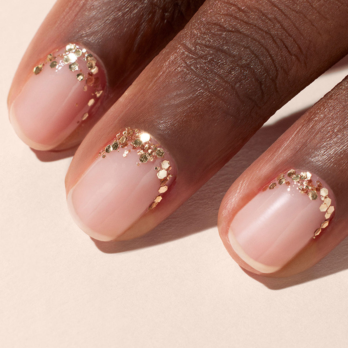 A close-up of a hand with neatly manicured nails showcases Manucurist&